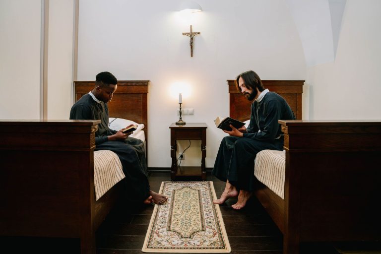 Two monks reading holy books in a serene monastery setting, reflecting faith and spirituality.