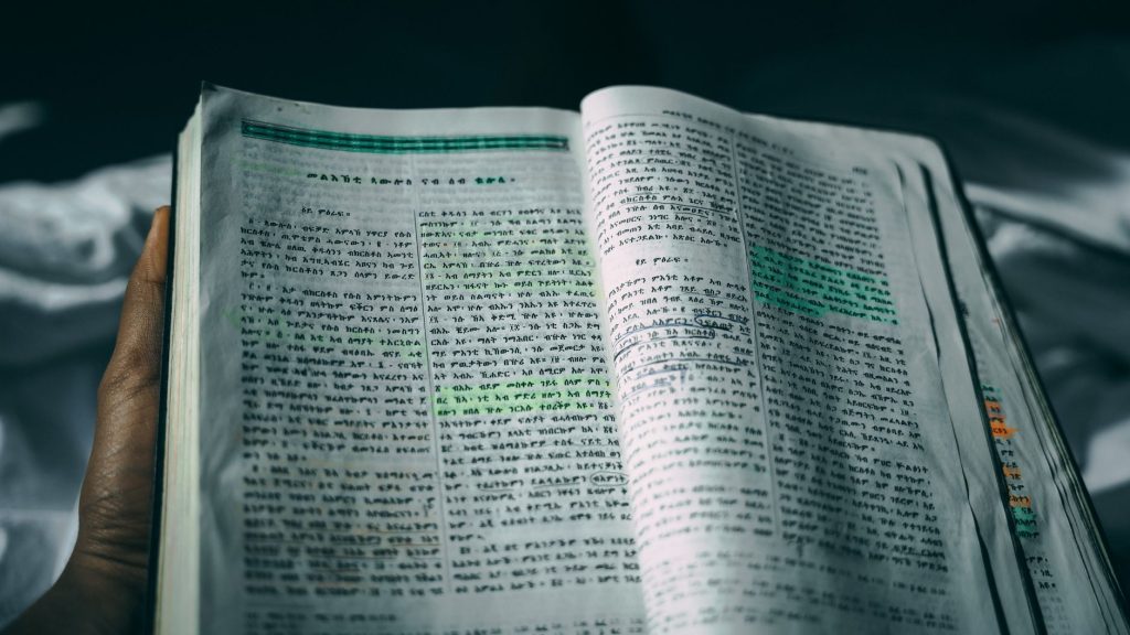 Open Bible with highlighted text, focusing on spiritual reading and study.