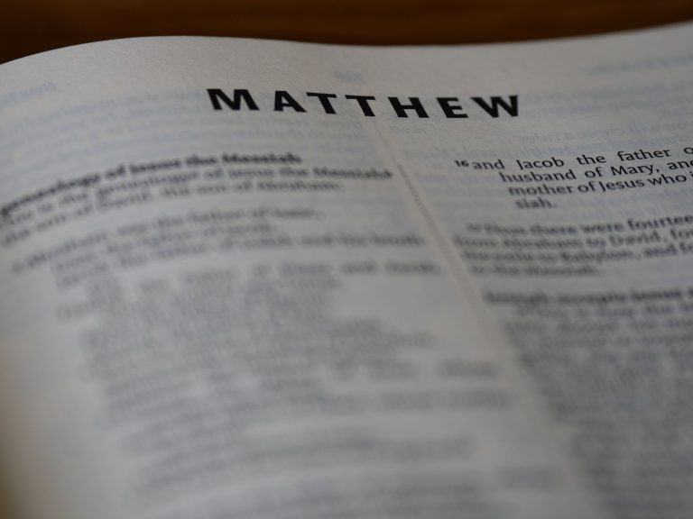 Close-up of an open Bible showing the Book of Matthew with selective focus.