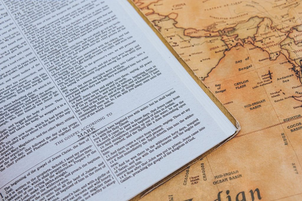 Open Bible on vintage Indian Ocean map showcasing text and geographical style.