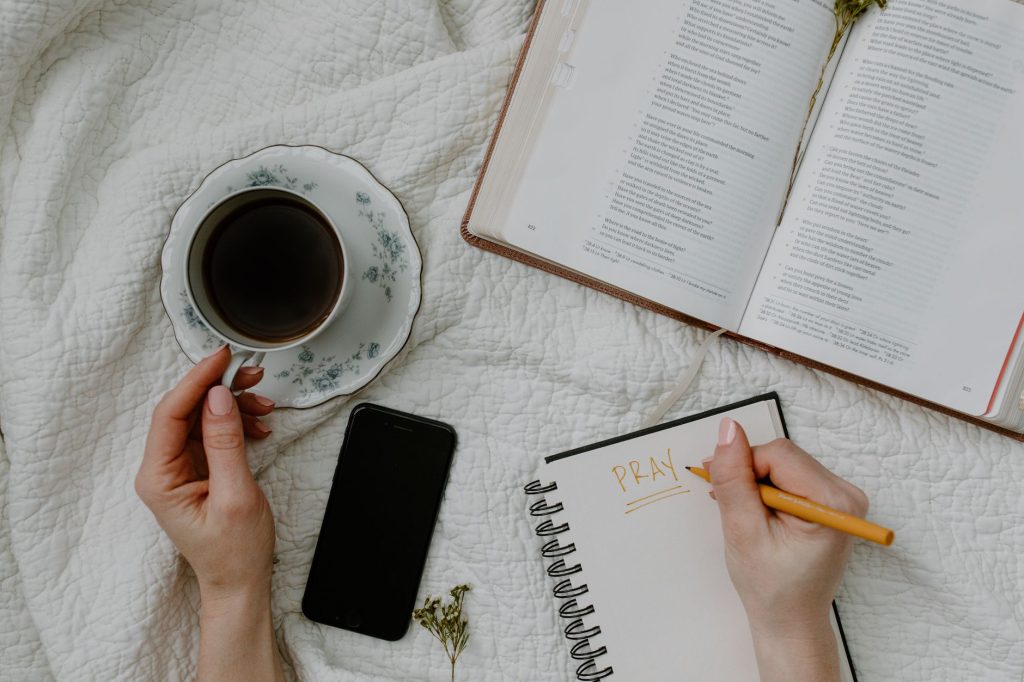 A serene morning meditation scene with coffee, Bible, and journal.