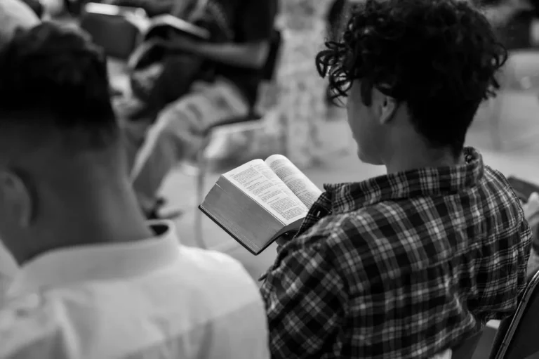 A young man reads a Bible in a prayer group setting in Ciudad de México.
